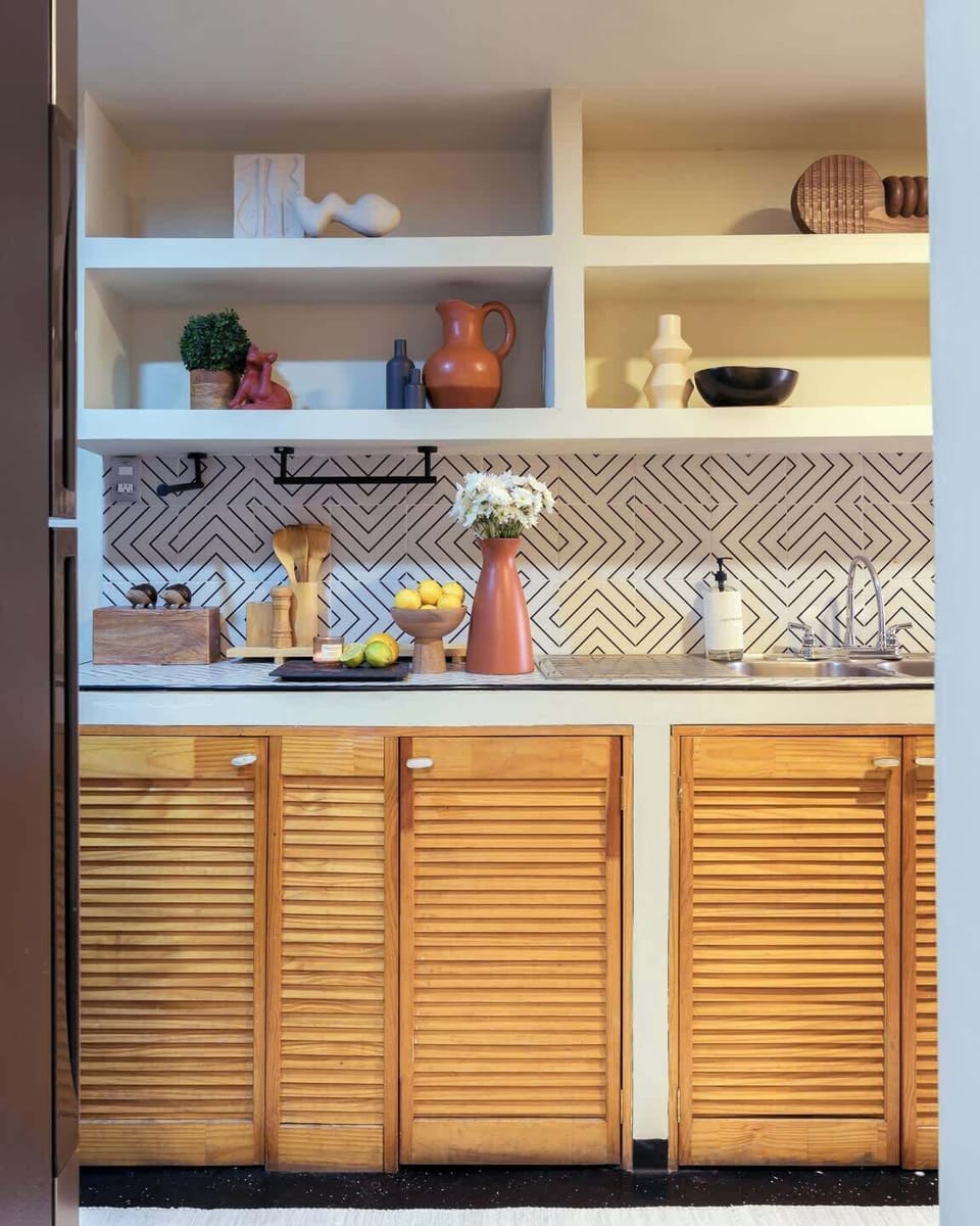 Warm and thoughtfully designed kitchen with handcrafted details, natural wood finishes, and plenty of space to cook comfortably, whether you're preparing a quick breakfast before exploring the city or enjoying a cozy dinner at home.