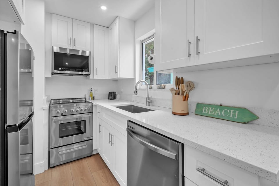Enjoy a clean, modern kitchen featuring ample counter space, updated appliances, and a fresh, inviting ambiance.