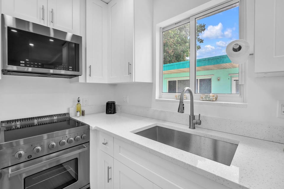 Enjoy a clean, modern kitchen featuring ample counter space, updated appliances, and a fresh, inviting ambiance.