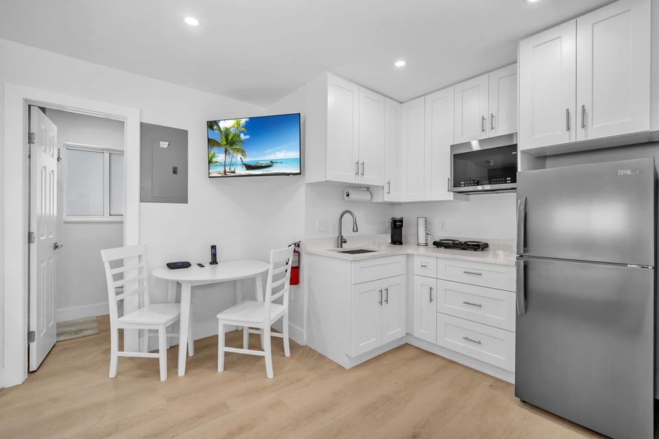 The kitchenette fully stocked with silverware, plates, and essential cookware, making it easy to prepare and enjoy meals during your stay.