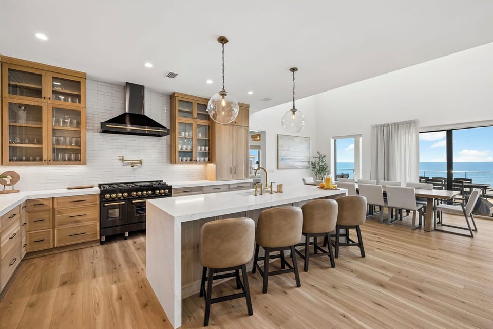 Your spacious gourmet kitchen flows into the dining area, where stunning ocean views greet you through expansive windows. Gather at the island or dine steps from the sea.