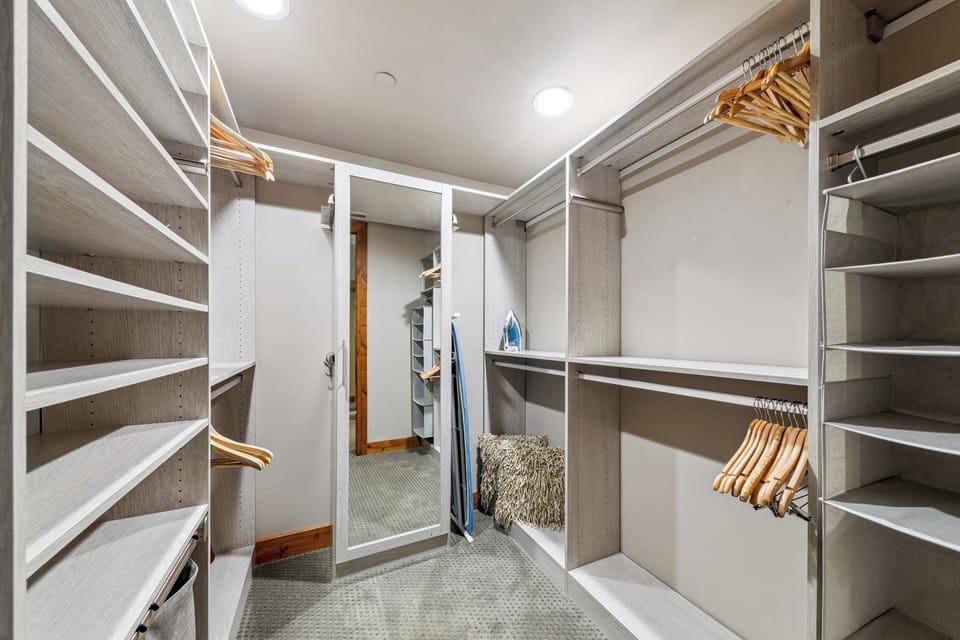 Store your wardrobe effortlessly in this spacious walk-in closet with custom shelving, hanging rods, and thoughtful lighting—everything you need to stay organized during your stay.