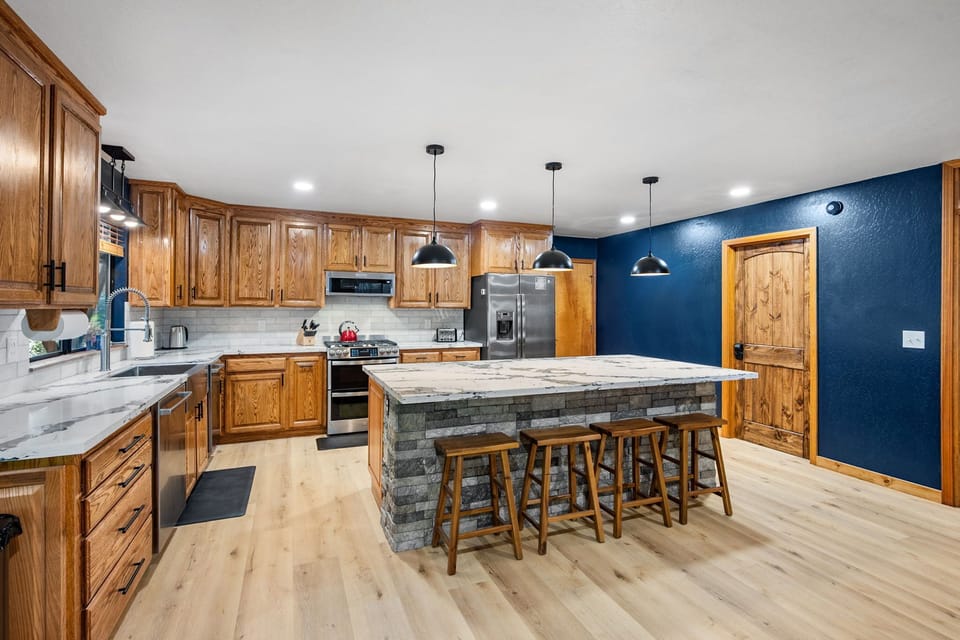 Quartz countertops, stainless steel appliances and a large island.