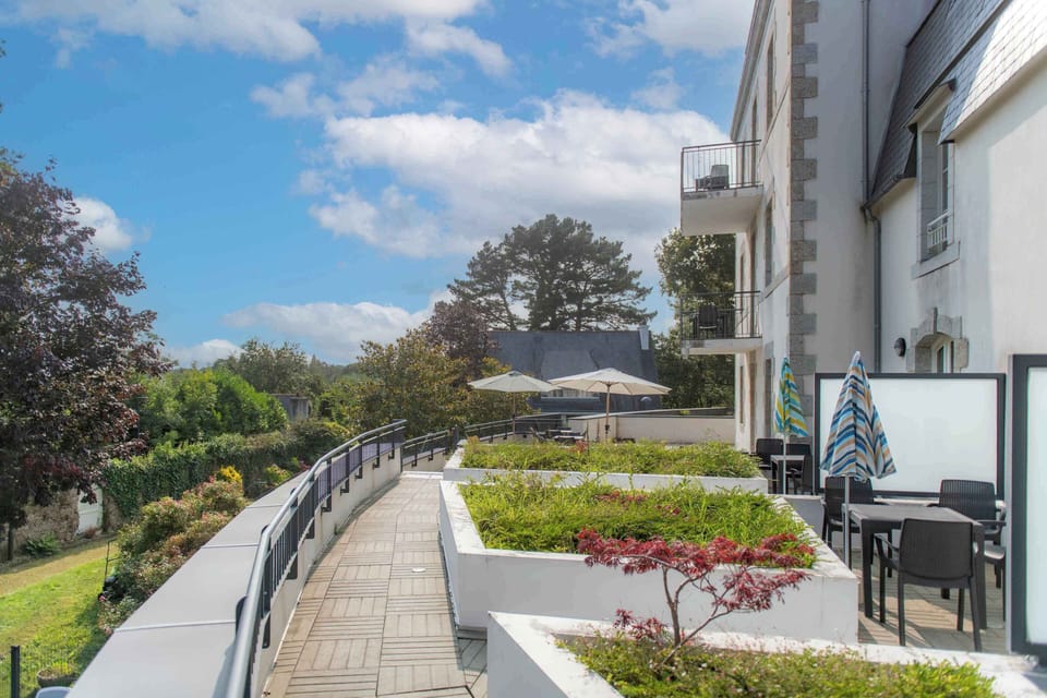 Breakfast or an afternoon read — the shaded terrace overlooking the park gives you a quiet spot above the town.
