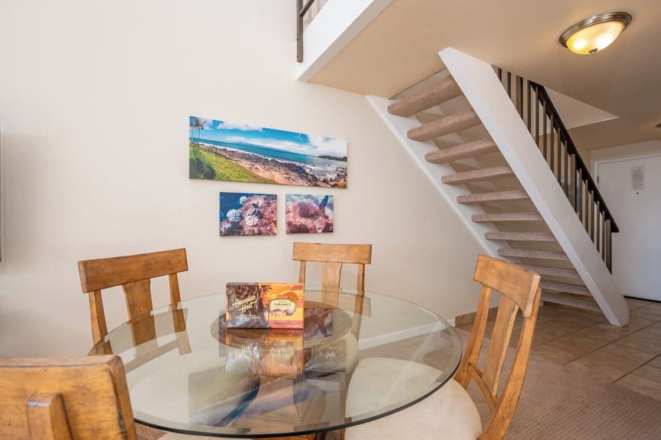 This sunny dining space offers lofted ceilings, modern tropical decor, and a cozy spot to enjoy meals and moments NAP-C18