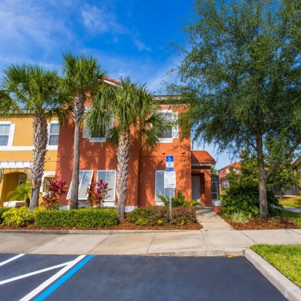 Charming villa with tropical landscaping and convenient parking.