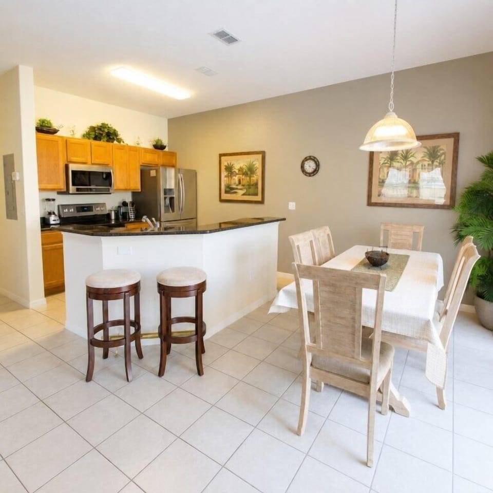Open kitchen and dining area with modern appliances and seating for family gatherings.