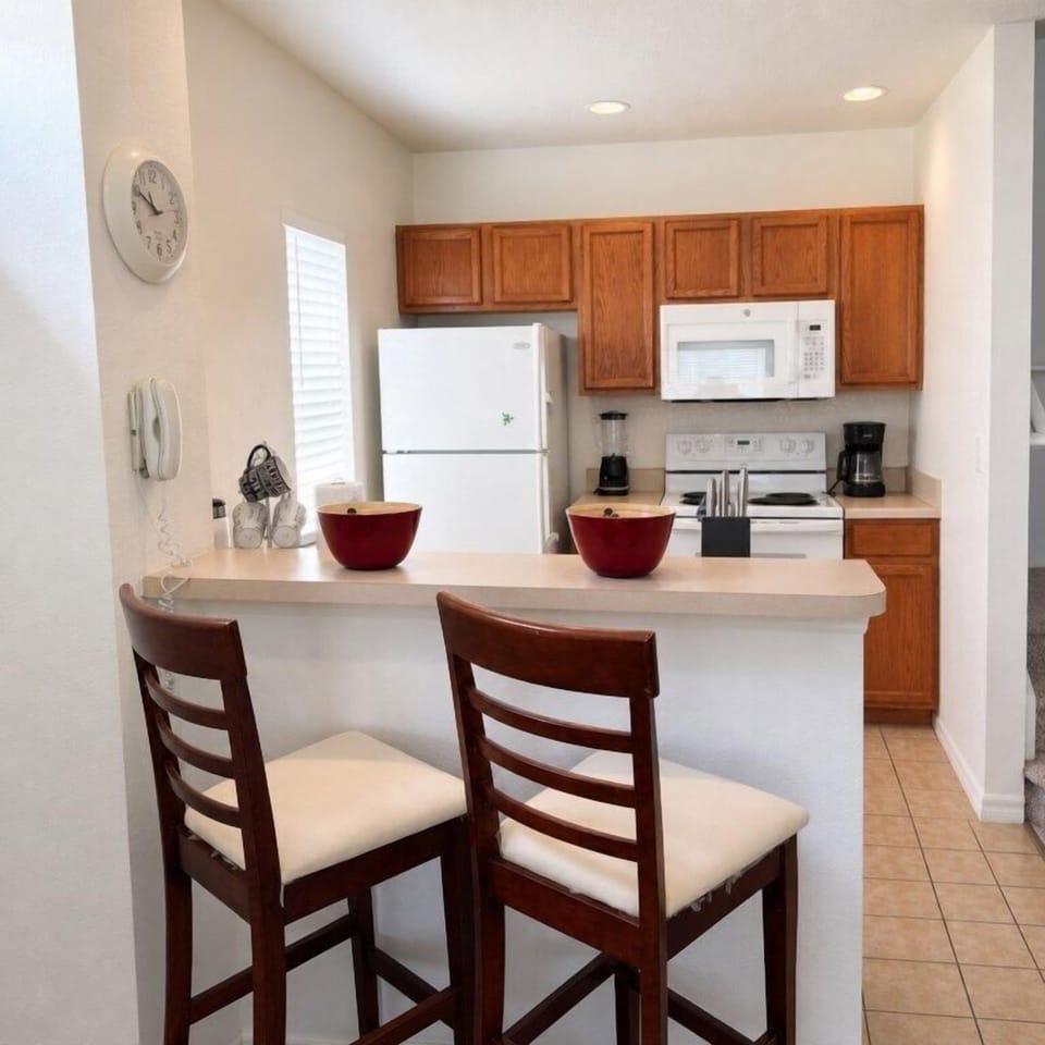 Cozy kitchen with breakfast bar and modern appliances for convenient meals.