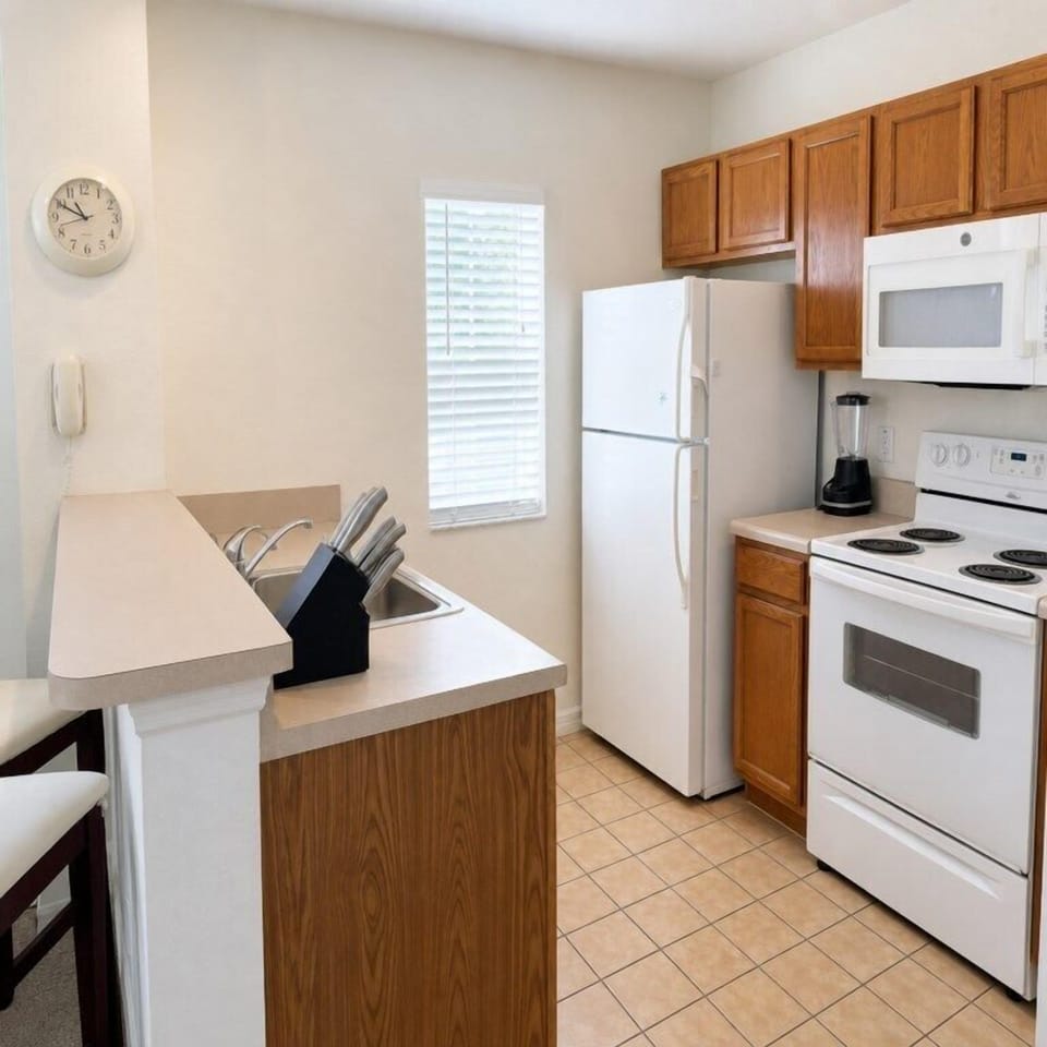 Cozy kitchen with modern appliances and ample counter space for meal prep.