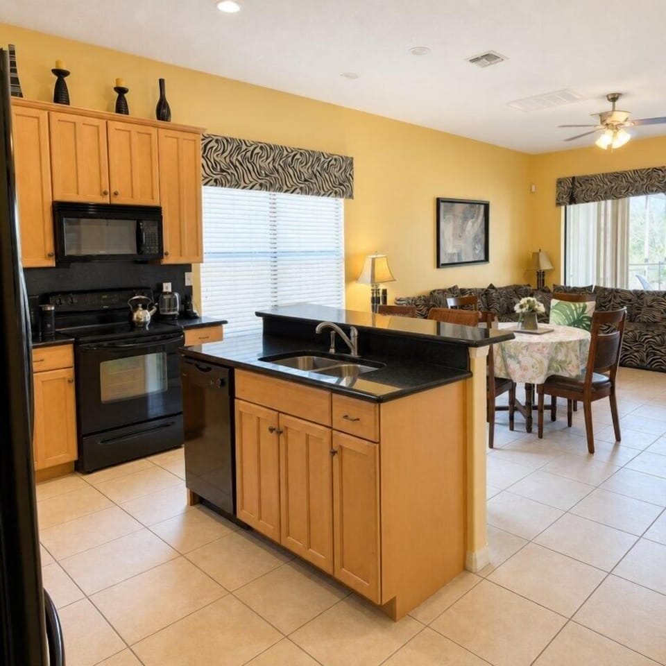 Open-plan kitchen and dining area with modern appliances and cozy seating.
