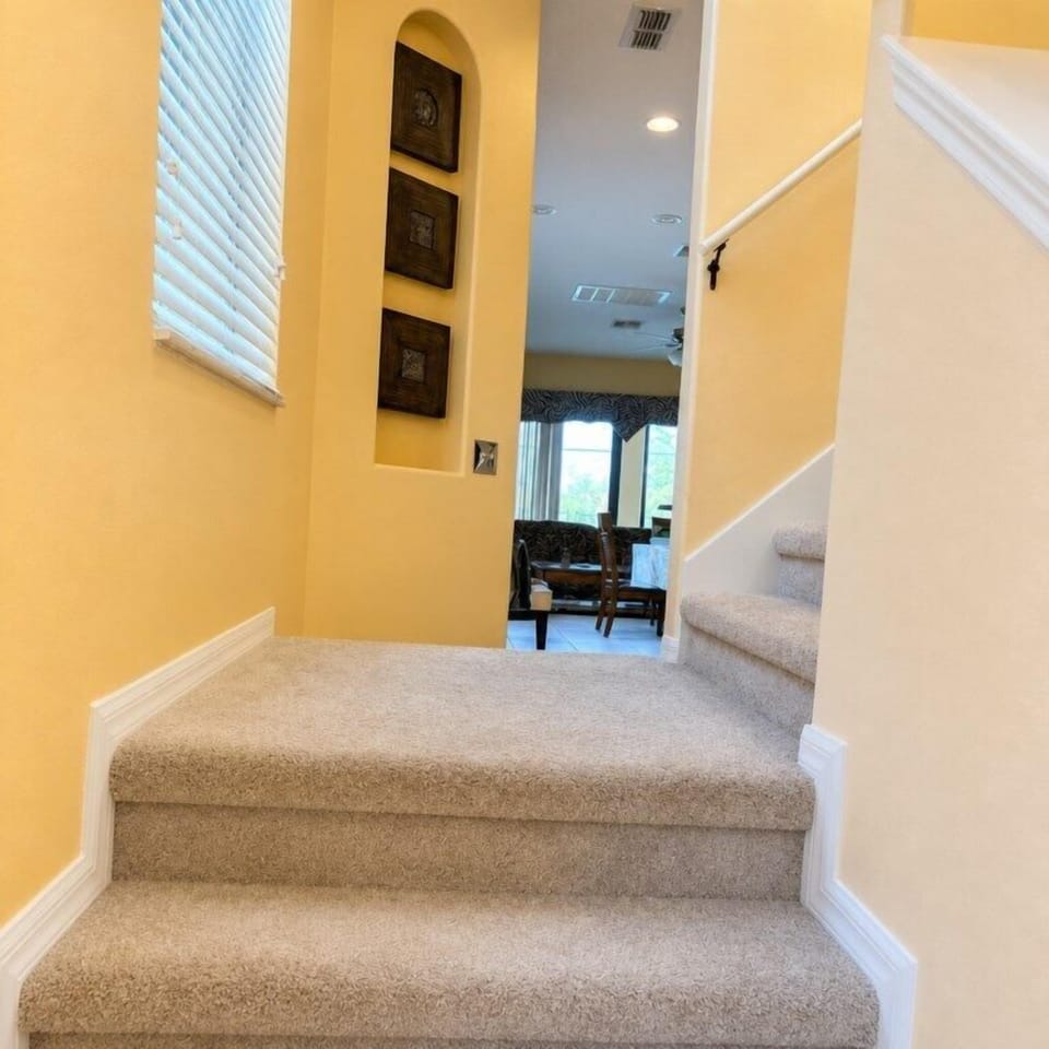 Inviting stairway leading to a cozy living area with natural light.