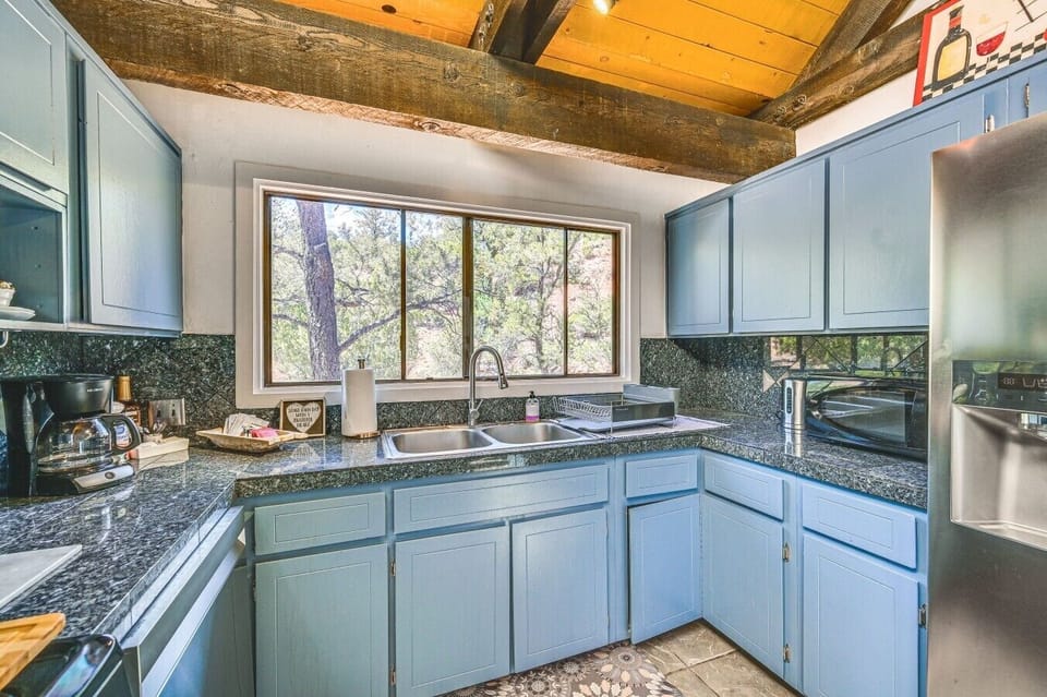 Kitchen | Gas Stove & Granite Countertops | Blue Cabinets & Forest Views