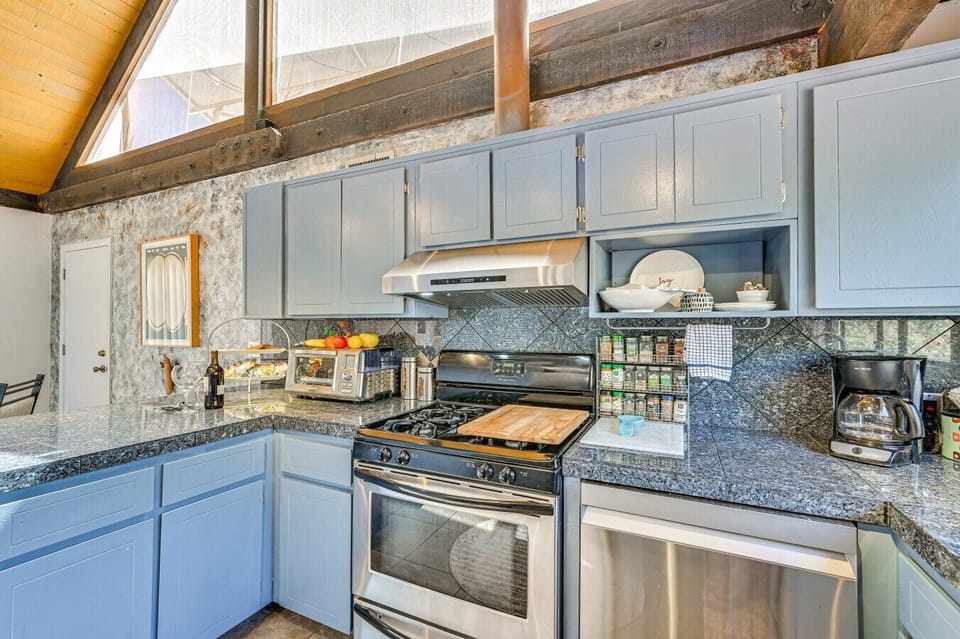 Kitchen | Gas Stove & Granite Countertops | Blue Cabinets & Forest Views