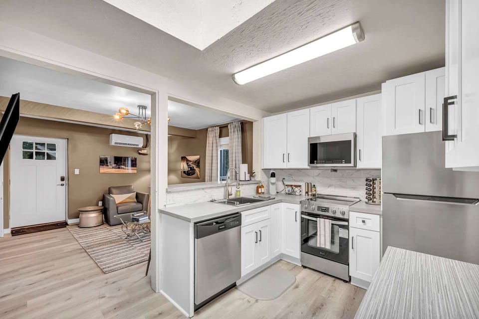 Functional kitchen w/ central island & full-size fridge.
