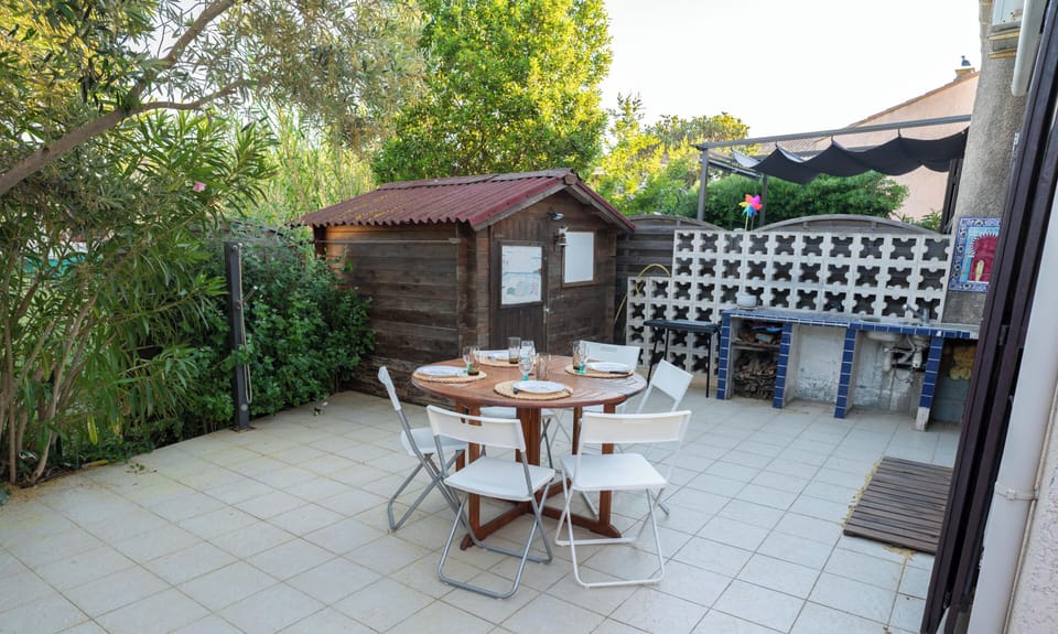 Large terrace with garden furniture and an awning