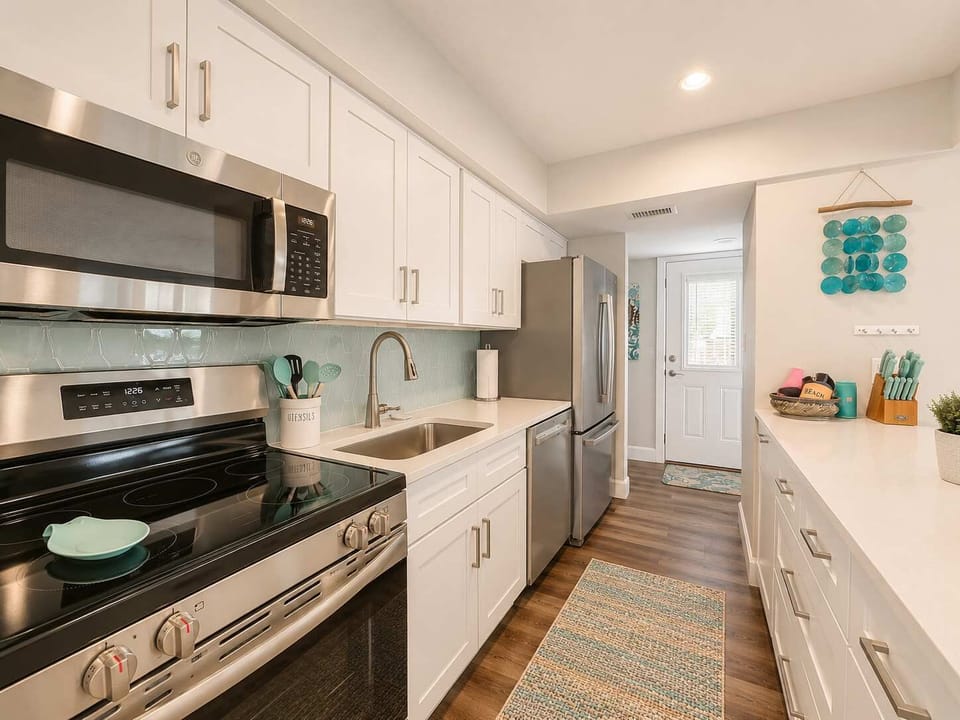 Your fully equipped coastal kitchen is the heart of the home. Featuring quartz countertops, stainless steel appliances, custom cabinetry, It's designed for effortless vacation living.