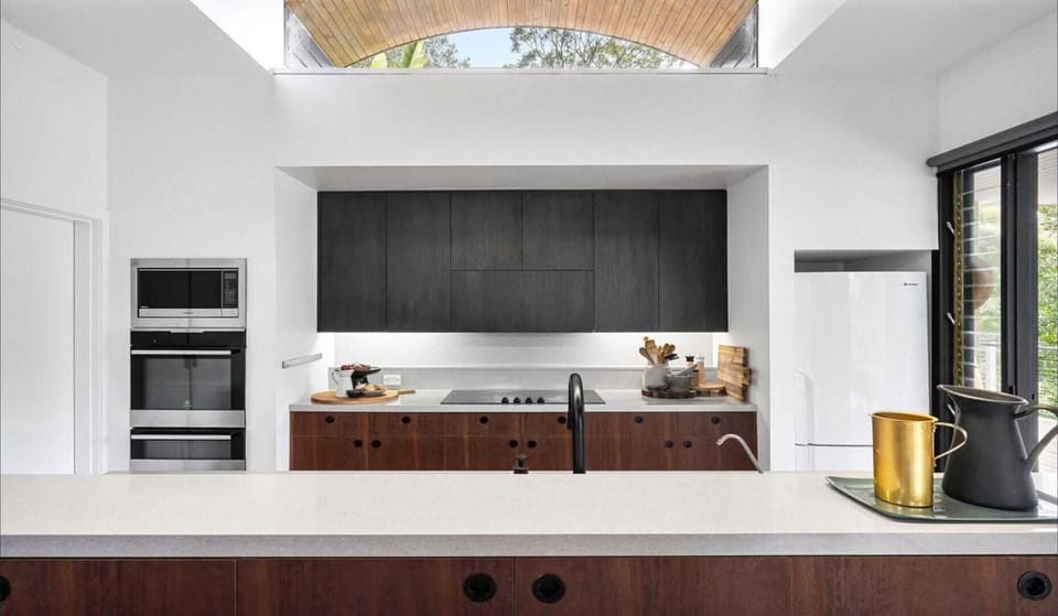 Open kitchen flowing into nature-filled living