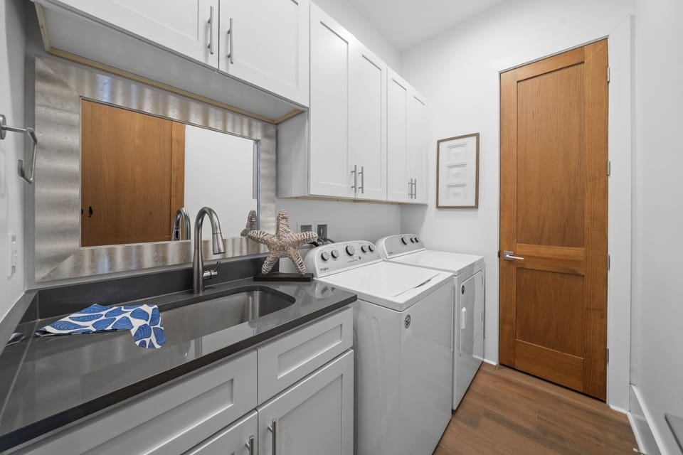 Full-size washer, dryer, and utility sink — pack lighter knowing you can refresh towels and beach gear mid-stay.