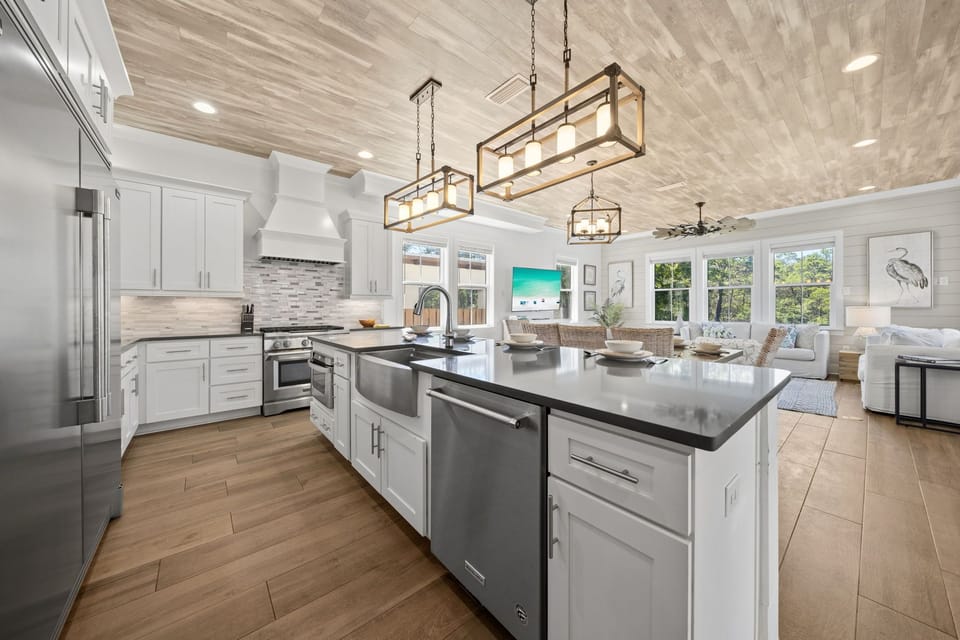 A kitchen built for real family meals — gas range, farm sink island, and room for everyone to pull up a stool and pitch in.