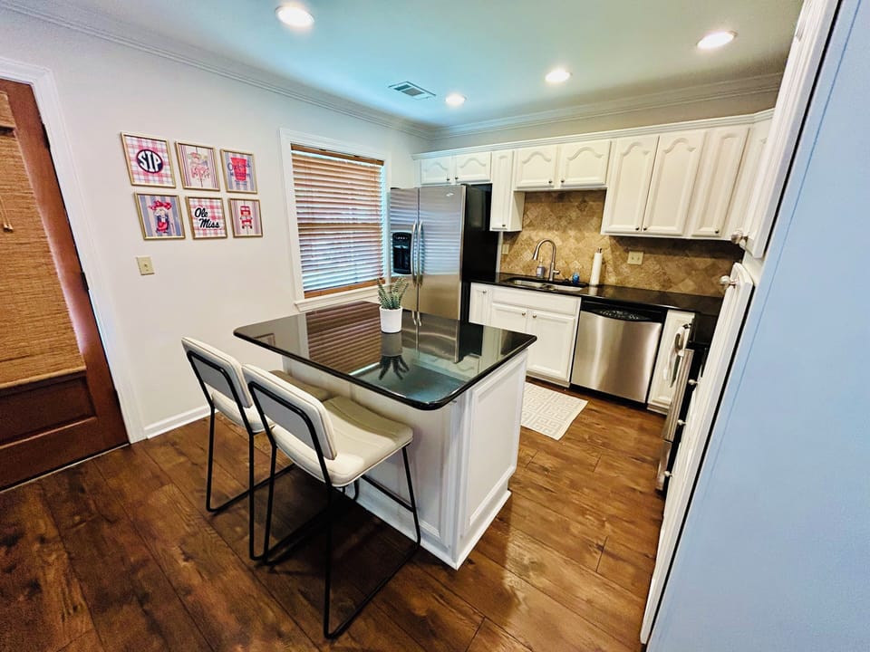Bright updated kitchen with island seating and stainless appliances