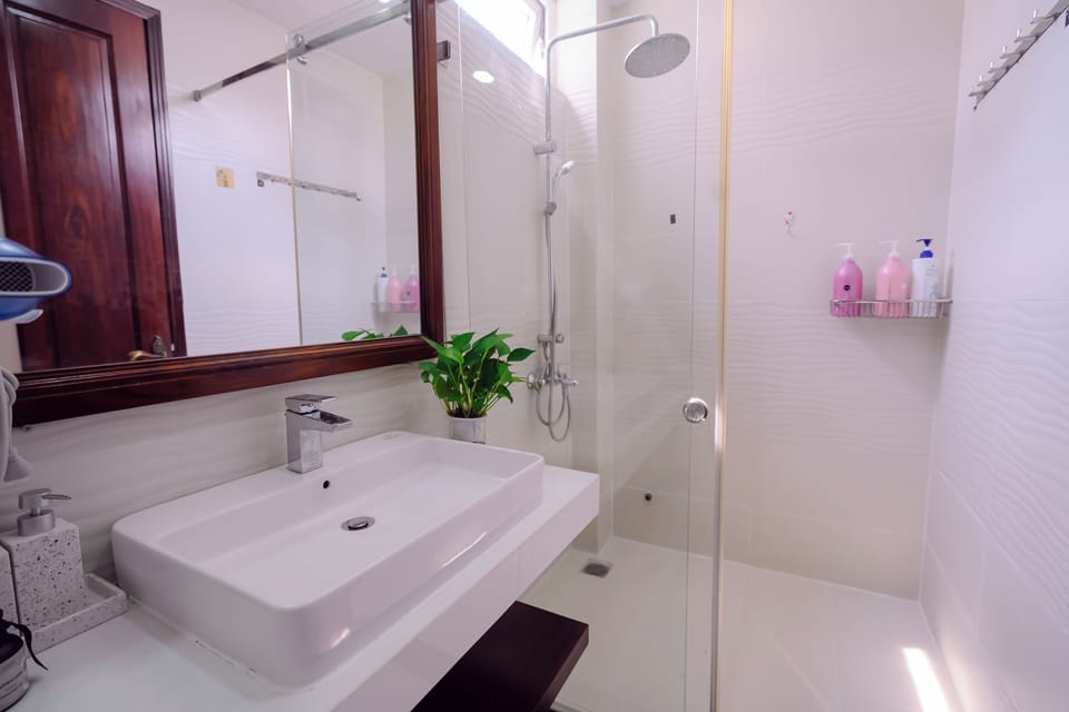 Deluxe Room, 1 King Bed with Sofa bed, Balcony, Courtyard View | Bathroom | Hair dryer, slippers, towels, soap