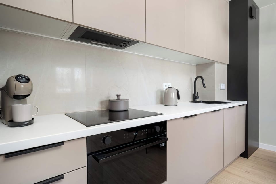 Modern kitchen with sleek cabinetry, built-in appliances, and minimalist finishes.
