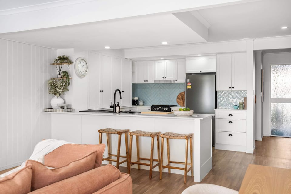 Spacious kitchen with dishwasher microwave oven and ample bench space