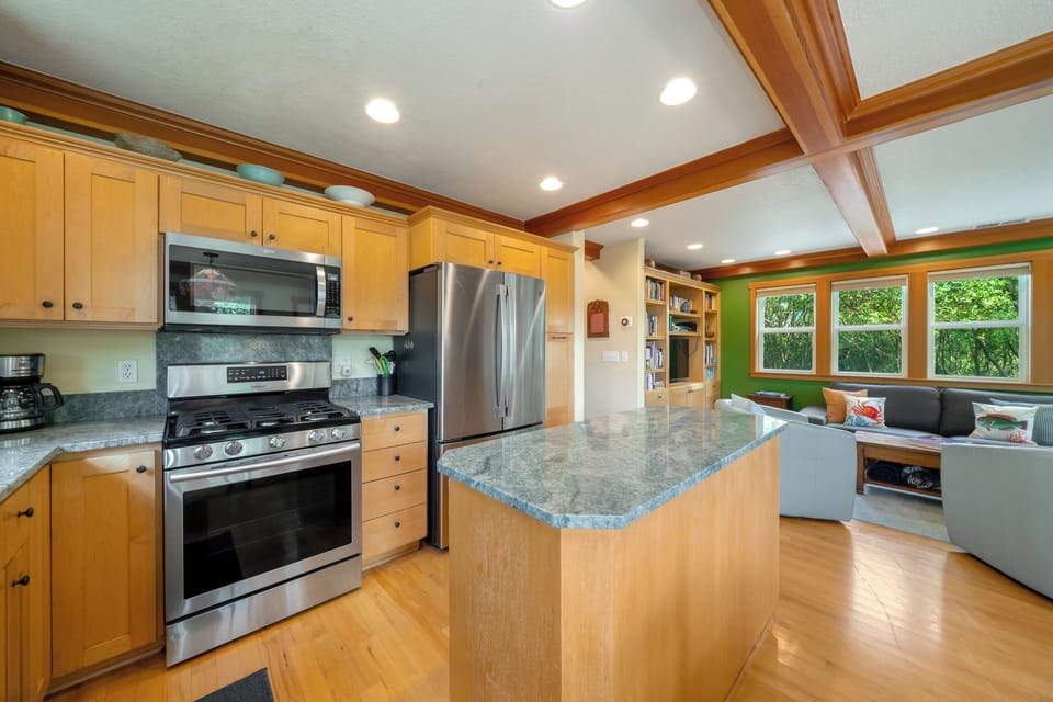 Fully equipped kitchen with gas stove and island. Open to living space and dining room.