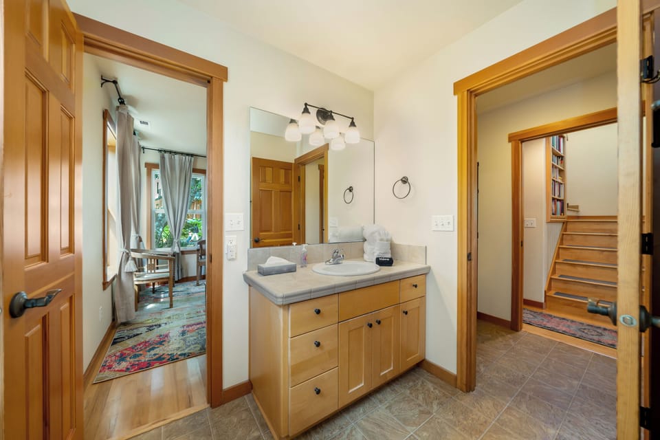 Main floor jack and jill bathroom that has access from King bedroom and the hallway with a tub shower combination.