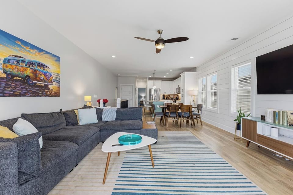 Sink into this plush sectional in your bright, open living area—complete with a cozy fireplace, stylish décor, and a seamless flow into the dining and kitchen spaces.