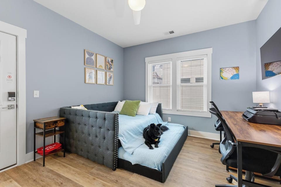 Your versatile guest room or home office welcomes you with soothing blue tones, a plush daybed perfect for relaxing, and a dedicated workspace. Your furry companion is welcome here too!
