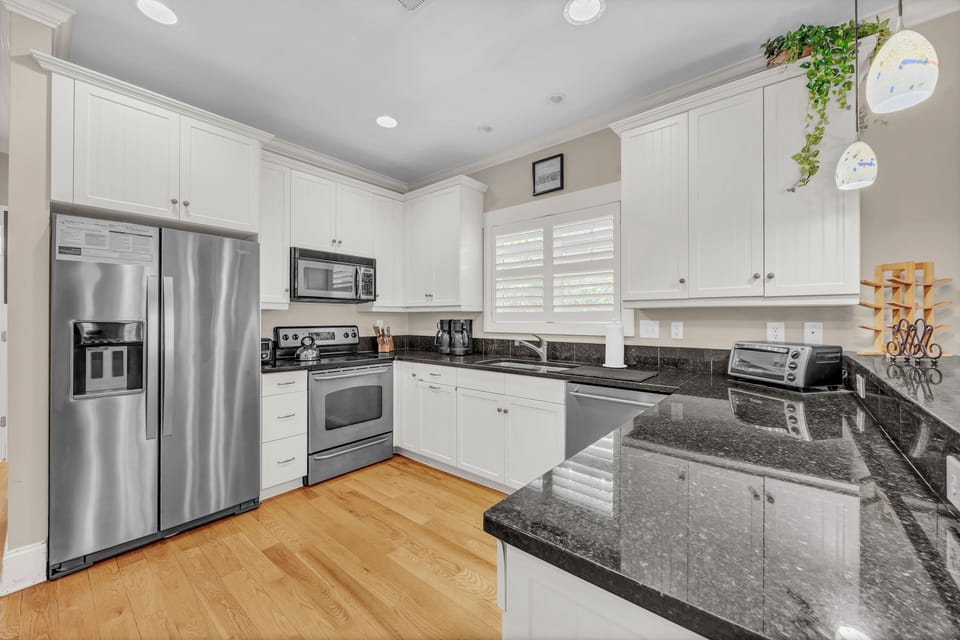 Your fully-equipped kitchen sparkles with granite counters, stainless appliances, and ample cabinetry—perfect for preparing delicious homemade meals during your stay.