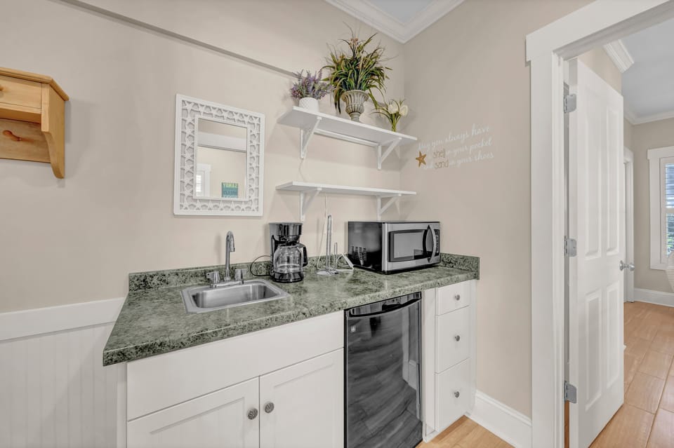 Your bright, fully-equipped kitchenette invites easy meal prep with granite counters, a microwave, dishwasher, and coffee maker—all the comforts of home in a charming coastal retreat.