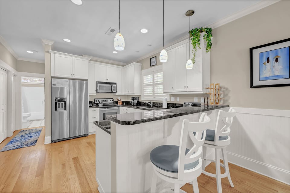 Bright, modern kitchen with stainless steel appliances, granite counters, and a breakfast bar where you can sip morning coffee or plan your next adventure.