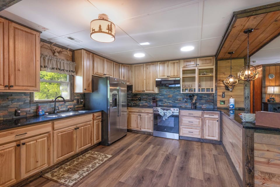 Kitchen – Custom Wood Cabinetry and Stainless Appliances - Full kitchen with slate tile backsplash and stainless appliances.