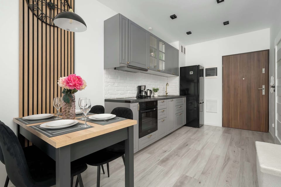 Open-plan dining space with a modern kitchenette and entrance area.