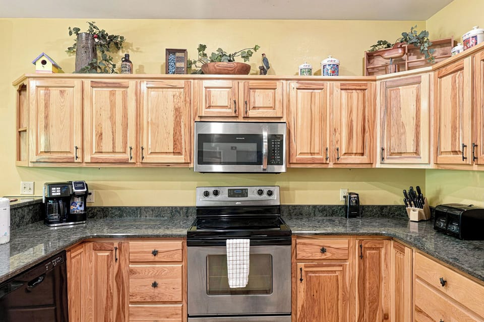 This fully equipped kitchen puts you right at home with oak cabinets, granite counters, and everything you need to prepare meals—from your morning coffee to a family feast.