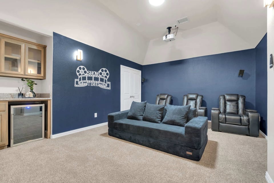 Movie night done right with a projector screen, comfy seating, and a built-in wet bar.