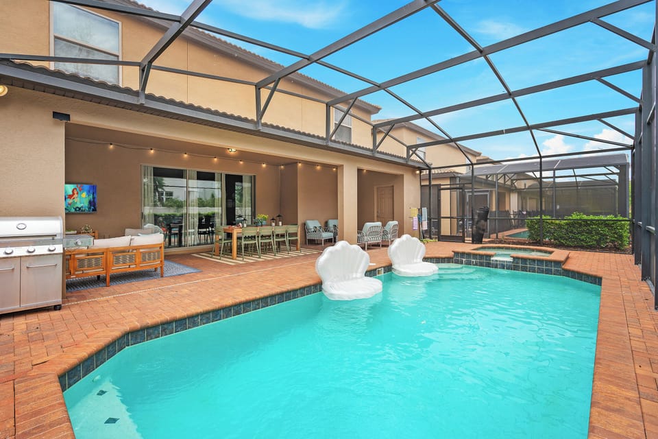 Private screened pool with royal patio seating for fairy-tale swims