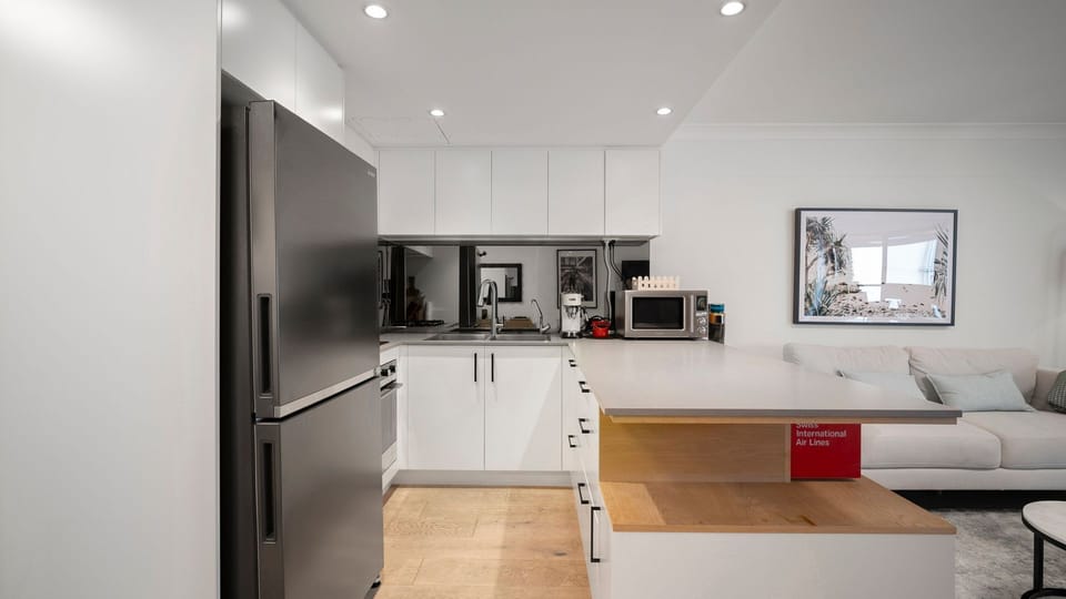 Fully equipped kitchen with stainless steel appliances and ample bench space.