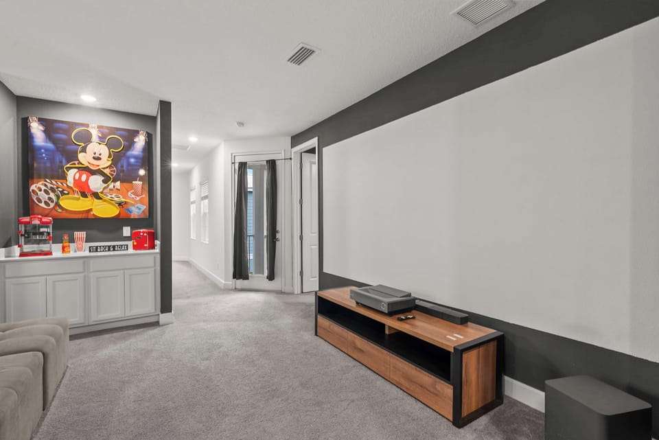 Family-friendly media room with projector screen and themed snack bar.