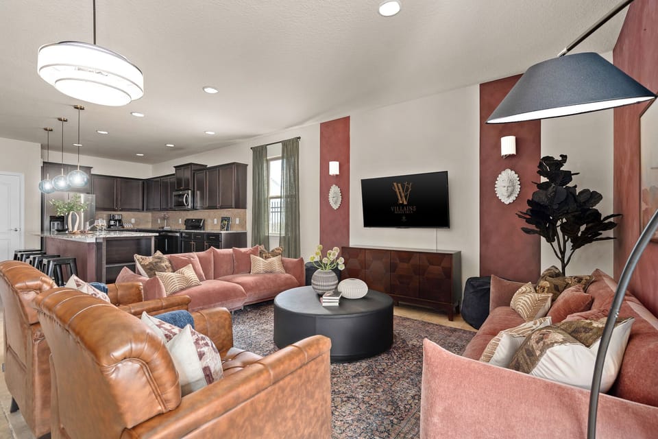 Main living room with sectional seating, television, chandelier