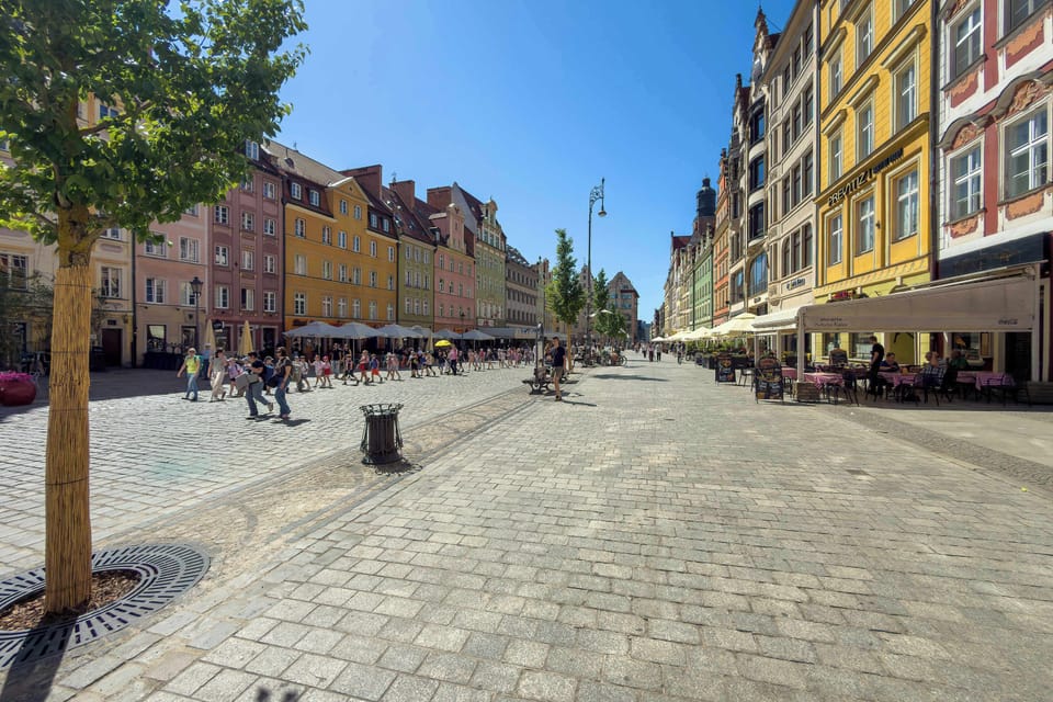 Wide city street view with colorful buildings and lively urban atmosphere.