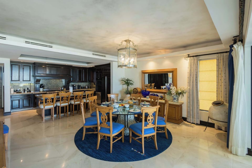 Elegant open-concept dining and living area with stylish décor, natural light, and comfortable seating.