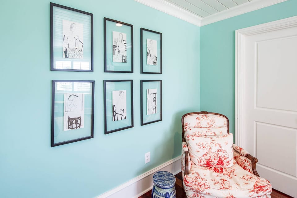 Tee primary suite also features an arm chair and a walk-in closet.