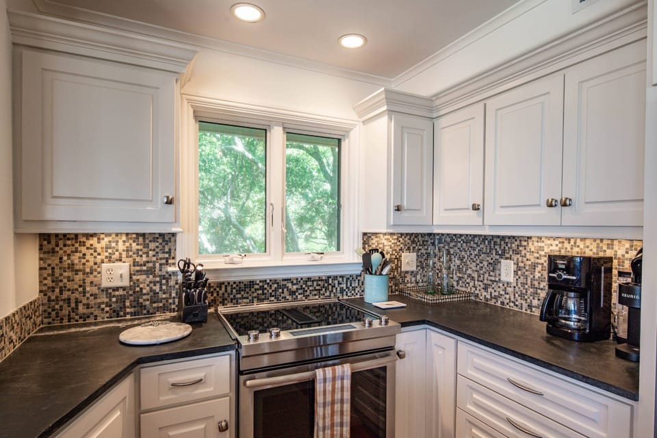 The kitchen features an electric range, drip coffee maker and keurig.
