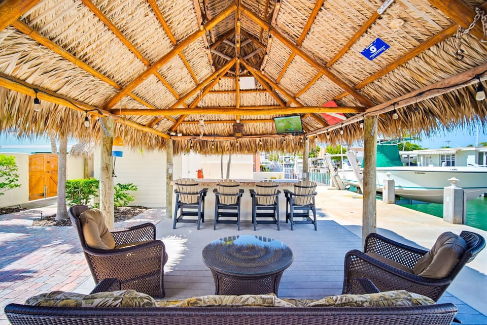 Your tropical backyard hangout just wouldn't be complete without a private tiki hut bar and lounge.