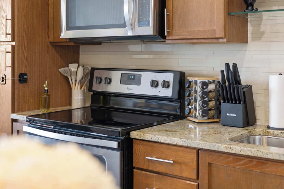 Fully equipped kitchen with modern appliances, ample counter space, and all the essentials for cooking and dining.
