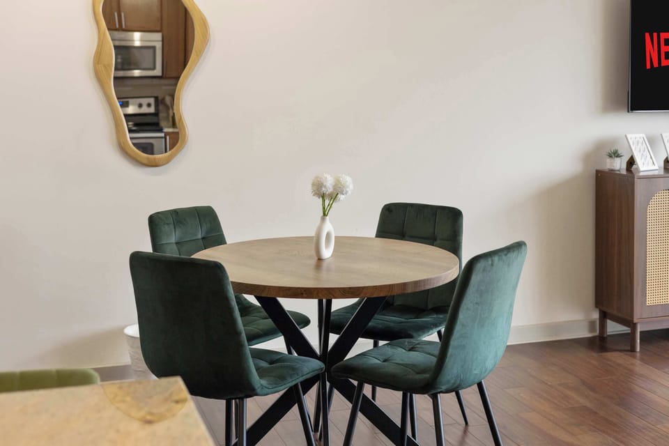 Elegant dining space with a round table and chairs, ideal for meals, coffee, or small gatherings.