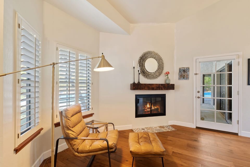Retreat to a spacious primary suite with a King bed, cozy fireplace sitting area, walk-in closet, and private en-suite bathroom for a relaxing stay.